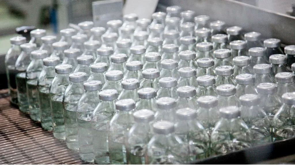 a group of clear bottles with silver caps